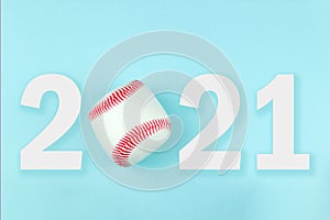 Small white red ball for baseball sport game on blue background with text 2021