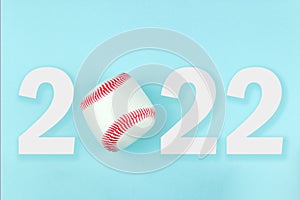 Small white red ball for baseball sport game on blue background with text 2022