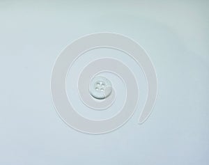 Small white round button on white background photo