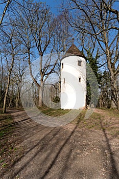 Small white tower next to green grass
