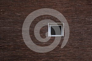 Small white window and red bricks wall
