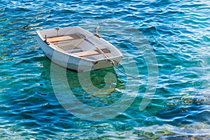 Small white wooden boat on Adriatic Sea