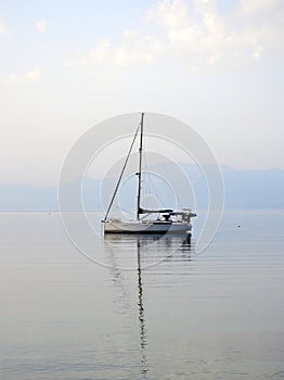 Small White Yacht Anchored in Bay, Greece