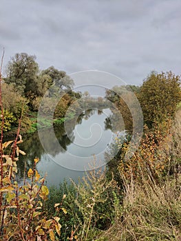 Small and wild Russian river. Beautiful view from the shore. Wild beach.