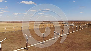 Small wind turbines with blades in the field aerial view. An old type of wind generator. alternative energy