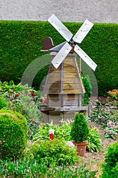 Small windmill among the trees in the garden