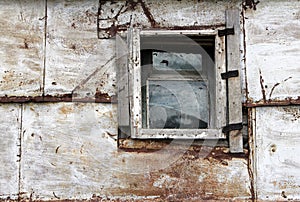 Small window of old rusty barn