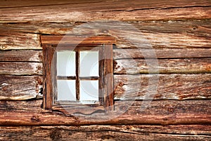 Small window in the old wooden wall