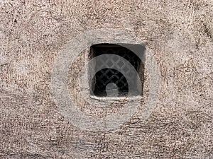 A small window in the wall of an old building in Kyiv