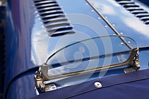 Small windshield on an old collector car for motor racing from the thirties british sports auto