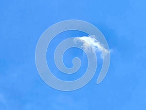 Small Wispy Cloud On Blue Sky