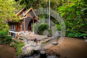 Small wood church thai style at kantrapruksa temple in Mae Kampong , surround by waterfall and evergreen foreste in Maekampong