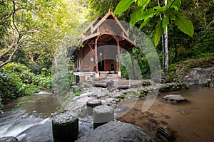 Small wood church thai style at kantrapruksa temple in Mae Kampong , surround by waterfall and evergreen foreste in Maekampong