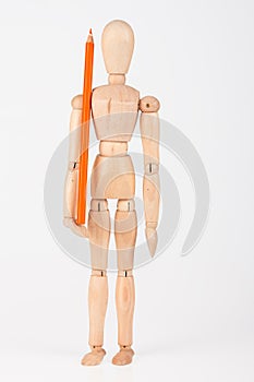 Small wood mannequin standing with colour pencil on whi