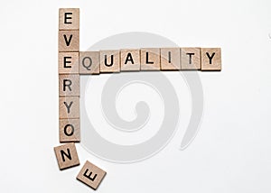 small wood squares with letters creating crossword puzzle spelling words equality for everyone