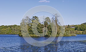 A small wooded Island with an old abandoned remains of a fortified House on but hidden by Trees, in the Loch of Clunie