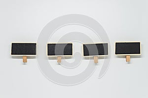 Small wooden black board clip on white background with selective focus