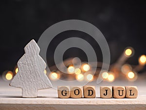 Small wooden blocks with God Jul and white wooden Christmas tree