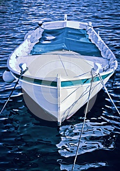 A small wooden boat anchored in the bay