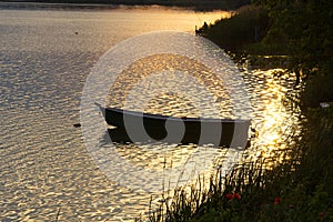 Small wooden boat on the lake