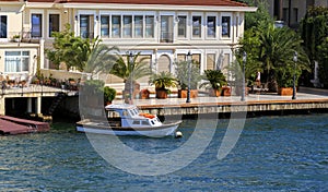 Small wooden boats in Bosphorus, residential house, Istanbul,Turkey.