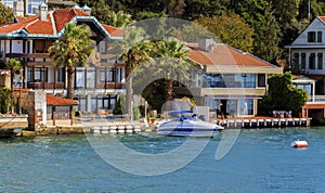 Small wooden boats in Bosphorus, residential house, Istanbul,Turkey.