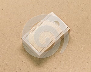 Small wooden box on brown texture background. Template of wood packaging made from oak material