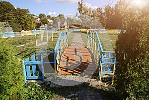 Small wooden bridge on children playground. Summer sunny day