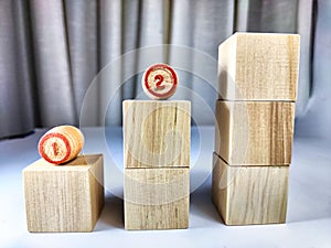 Small wooden cubes in columns, lined up in row. The concept of progressive movement in achieving the goal. Steps and