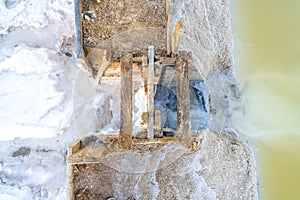 A small wooden dam between salt ponds at salines in Faro, Portugal