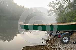 Small wooden dinghy or rowboat on a trailer