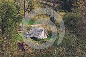 Small wooden house or barn on hillside