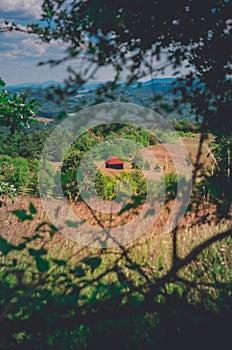 Small wooden house with a red roof on the mountain countryside