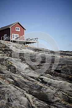 Small wooden house at a rocky island