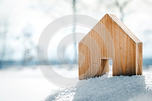 Small wooden House standing in the snow, planning Housebuilding on the building area photo