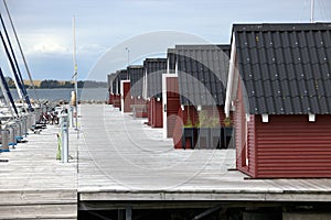 Small wooden houses on dock on the shore of the lake