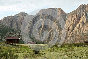 Small wooden houses in the valley with mountains on the back