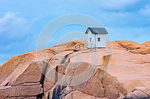 Small Wooden Hut On A Granite Rock