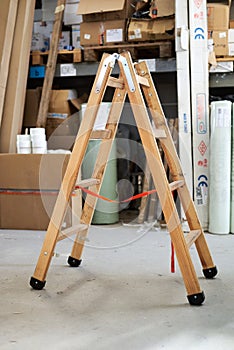Small wooden ladders stand in the warehouse