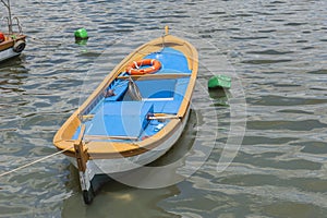Small wooden motor boat moored up