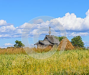 Small wooden old orthodox church in the field. Kizhi island pogost