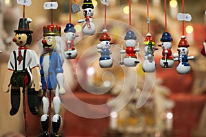 Small wooden snowmen as christmas-tree decorations