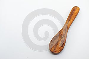 Small wooden spoon on a white isolated background