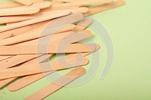 Small Wooden sticks on a green background