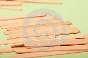 Small Wooden sticks on a green background