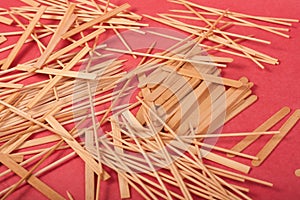 Small Wooden sticks mix on a red background