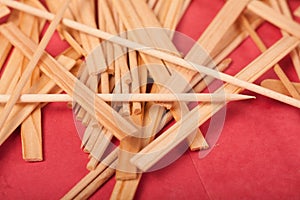 Small Wooden sticks mix on a red background