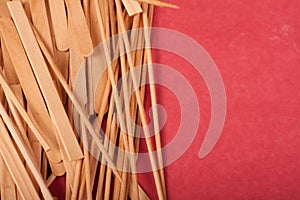 Small Wooden sticks mix on a red background