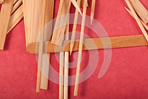 Small Wooden sticks mix on a red background