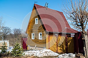 small wooden summer house in early spring in Russia